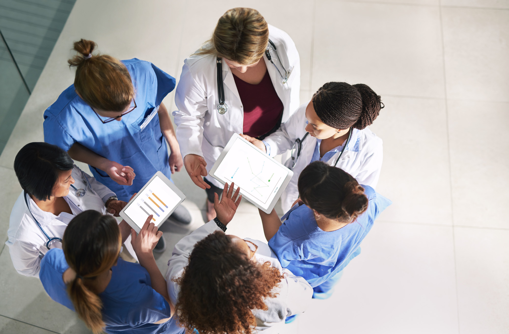 High angle shot of a group of medical practitioners analyzing data in a hospital